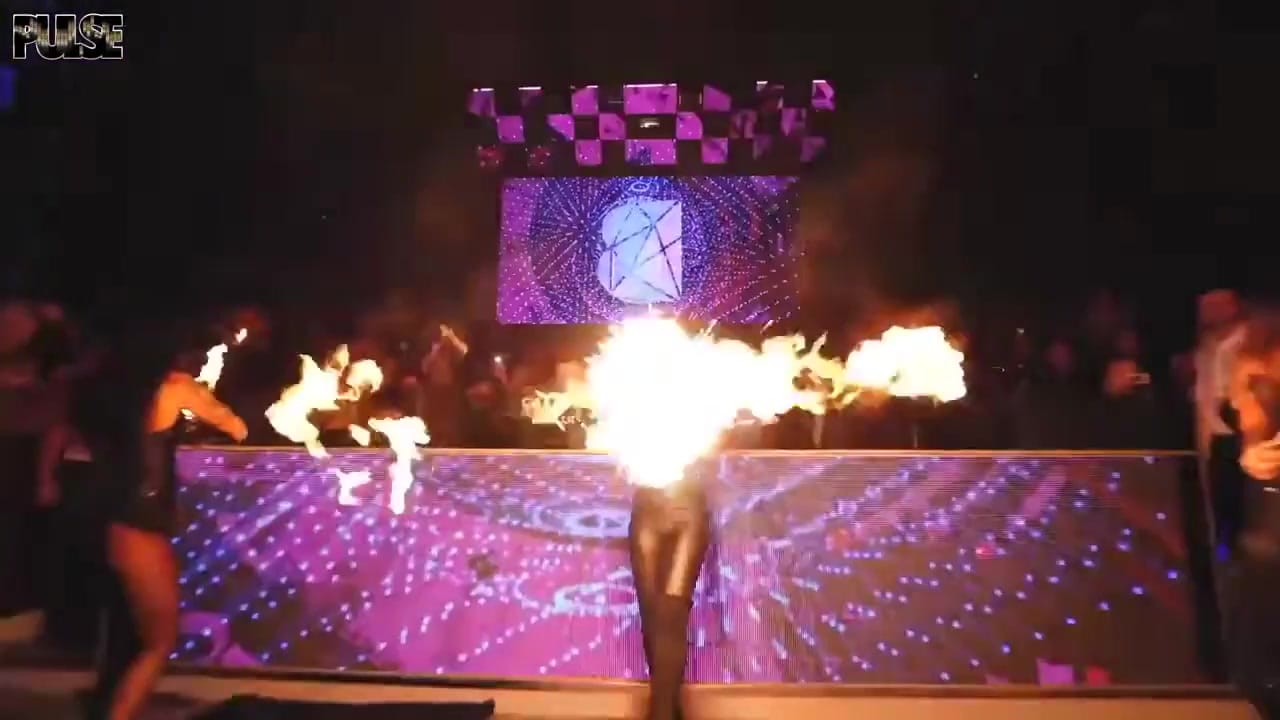 The club floor at BASE Dubai under a purple light rig